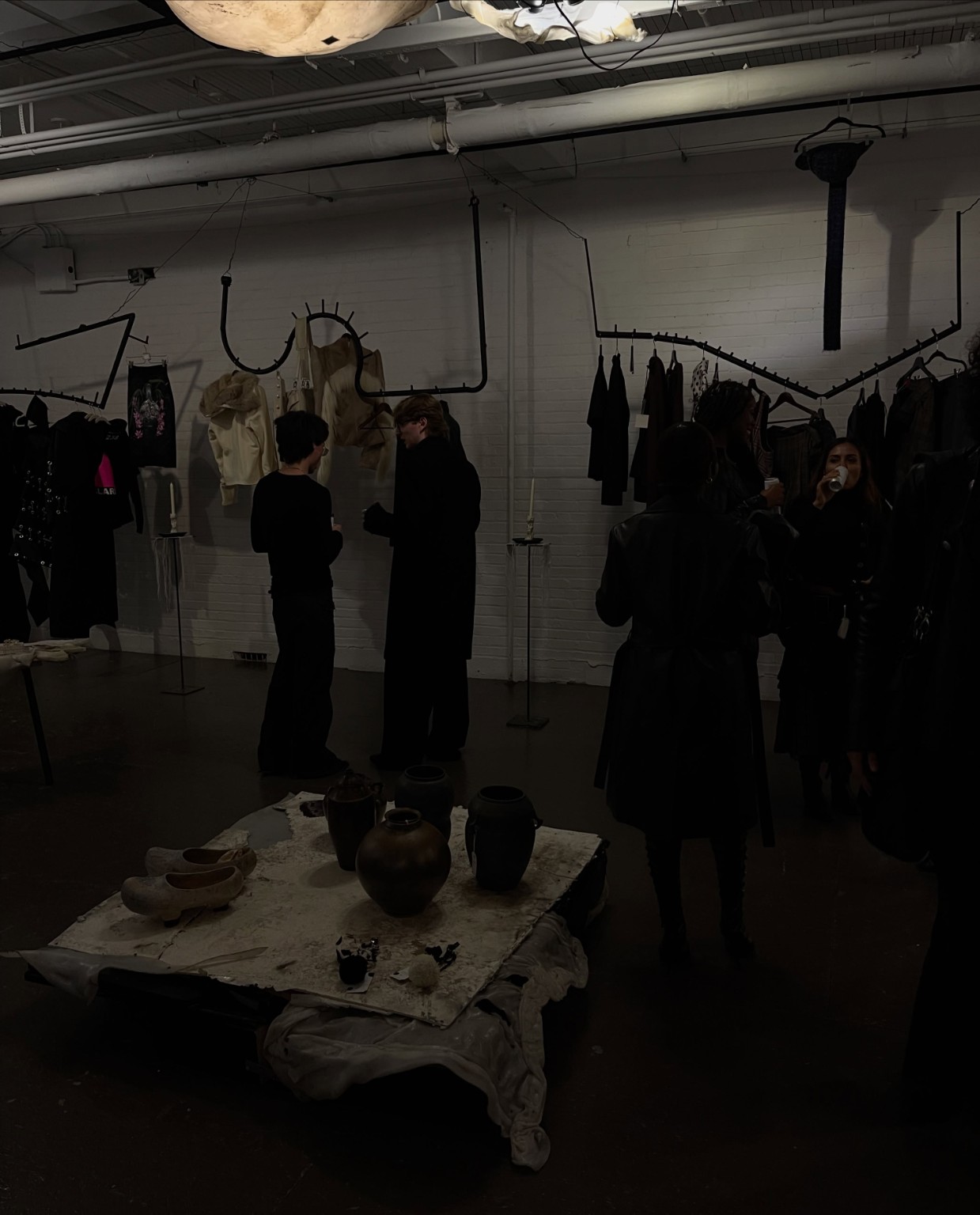 Guests moving through the LDF showroom among sculptural racks and independent fashion during Montréal Fashion Week in September 2026.